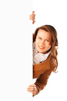 Portrait of a young attractive smiling business woman holding a big poster on one side, isolated over white background