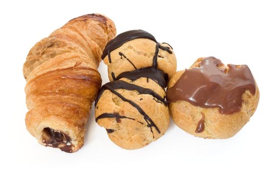 three chocolate and nut pastries isolated on white background