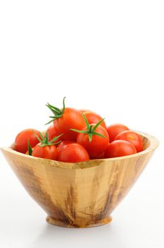 Wooden bowl of fresh picked ripe tomatoes.