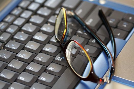 A closeup shot of glasses on a laptop