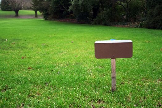 A sign on a grass field