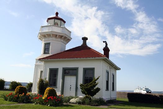 Old historic lighthouse with cruise in the background