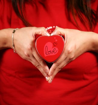 A woman holding a heart-shaped box