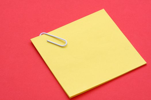 Blank yellow note on red background