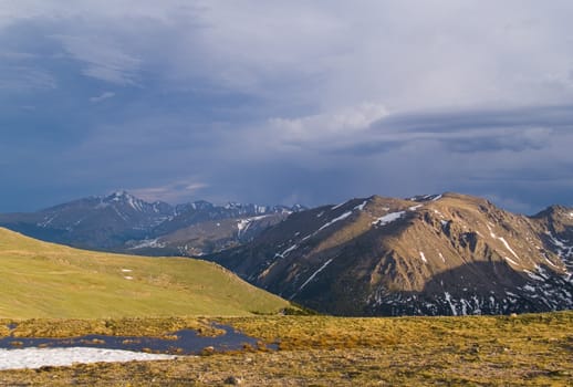 Rain over Trail Ridge in Rocky Mountain National Park.  Stones Mtn. in the foreground and Longs Peak in the distance ..