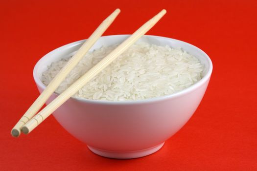 A bowl of rice, red background