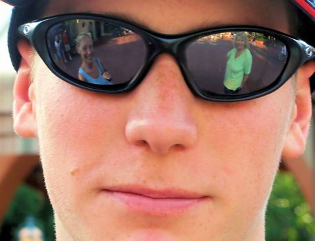 Model and photographers Mom reflected in Models sunglasses.