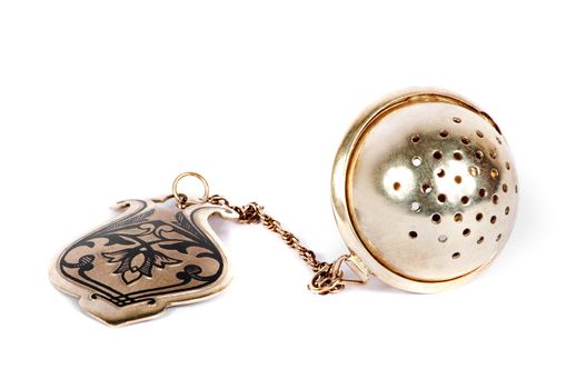 Old silver tea-strainer on a white background