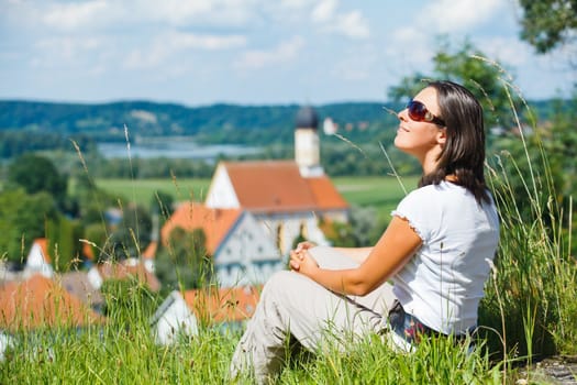 Young pretty woman on vacation. Looks at an old European city