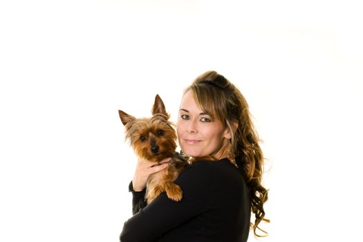 Studio portrait of attractive woman holding a yorkshire terrier dog