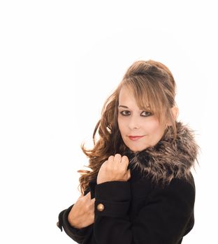 Studio portrait of attractive woman wearing a coat with a fur collar