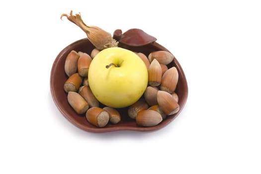 bowl with apple and hazelnuts