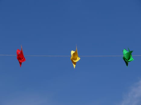 red yellow and green windmill in front of blue sky