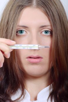 The nice girl with a thermometer removed close up