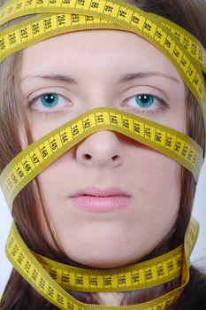 The girl with measuring metre wrapped up round a head