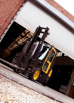 industrial forklift in front of the warehouse