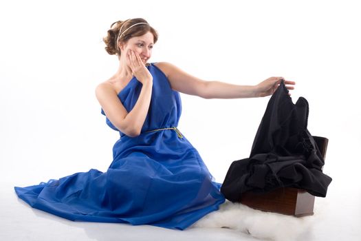 Lady in blue antique dress and open box on white background
