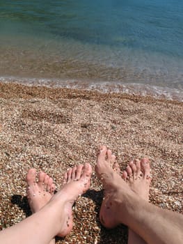 Two pair bare foot on the sea coast