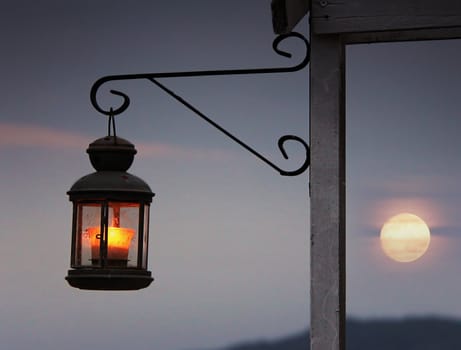 Old romantic lantern in front of the sunset