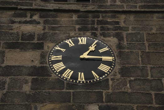 A Vintage Black and Gold Clock on a Church Tower