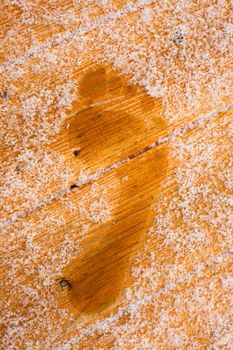 Barefooted human foot prints on frosted wooden deck planks (after sauna bath).