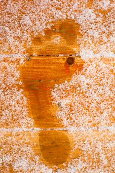 Barefooted human foot prints on frosted wooden deck planks (after sauna bath).