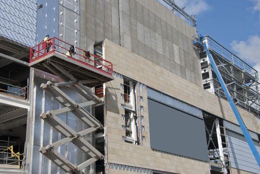 A Scissor Lift Platform and a cherry picker on a construction site