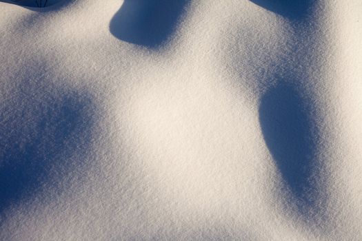 Shadows on curved surface of freshly fallen snow.