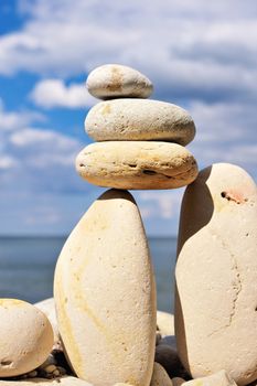 Three pebble in balance between the two boulders