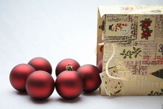 A christmas giftbag with red christmas balls