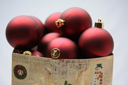 A christmas giftbag with red christmas balls