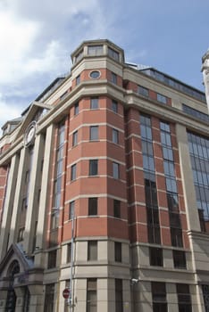 A Red Brick and Glass Office Block with Modern Clock