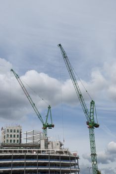 Two Green Tower Cranes a building under construction