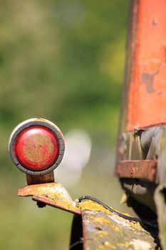 Detail image of the indicator from a farm tractor. Set against a soft focus green background. Shallow depth of field to image.