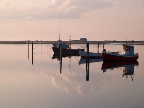 Magical reflection of a small dinghy dory boats in the sunset great sailing boating fishing image