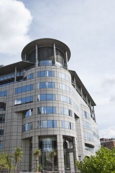 A Cream Coloured Office Block with round front and tower