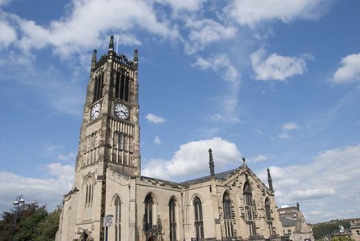 The Parish Church and Clocktower of a Yorkshire Town under a blue sky