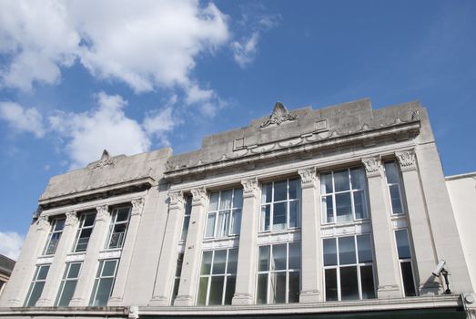 The Frontage of an Art Deco Building under a blue summer sky
