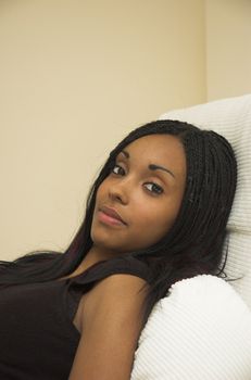 Beautiful young black woman relaxing at home.