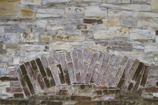 background or texture of a stone wall with brick insertion