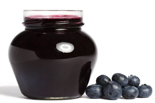 jam jar with blueberry jam and blueberries aside on white background