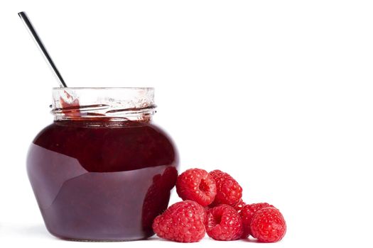  raspberry jam jar with a spoon and raspberries aside on white background