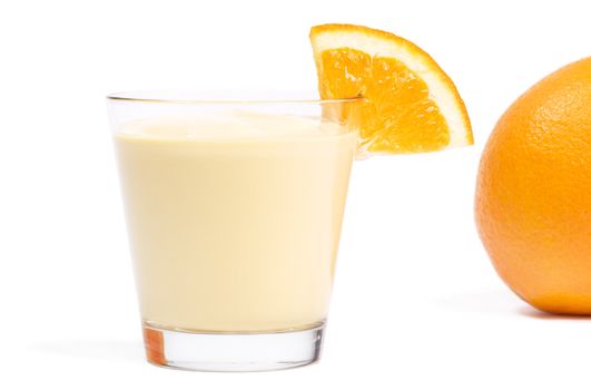 milkshake with a piece of orange and orange in back on white background