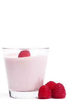 raspberry on a milkshake with raspberries aside on white background