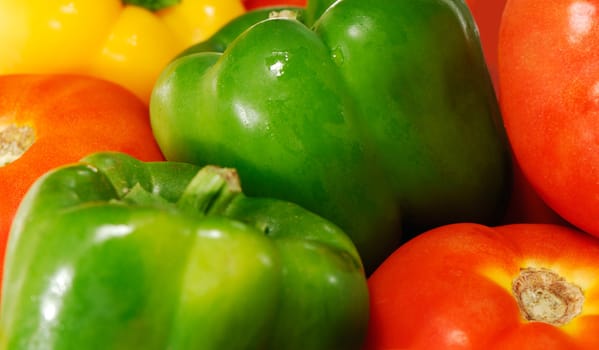 Close-up image of freshly picked tomatoes and  peppers of various colors