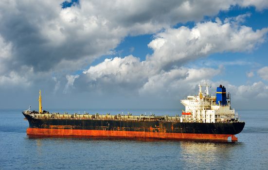 Old and rusty cargo ship laying empty, due to state of world economy