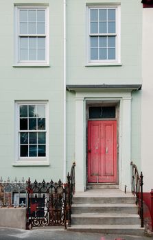 Red  door and window. A red door with ladder steps and windows.Guernsey
