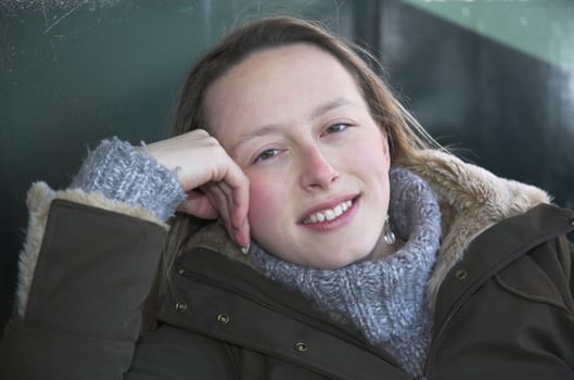 Portrait of a young woman wrapped up on a chilly winter's day.