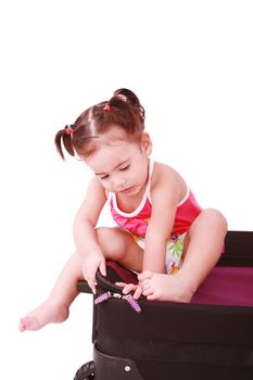 little girl in a suitcase, isolated on a white background