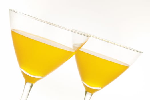Close-up of two cocktail glasses with yellow liquid inside and lot of copy space